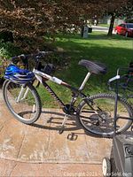 Side view of bike with blue/white helmet hanging from handlebar