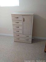 Front view of the Palliser chest of drawers with cabinet closed, showing six drawers and one cabinet door, wood finish and metal handles.