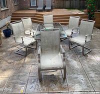 Overall set of rectangular glass-top table and six chairs on patio