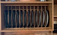 Stoneware dinner plates vertically stored in wooden rack