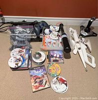 Full lot overview showing console, controllers, discs, accessories, joystick, and cables