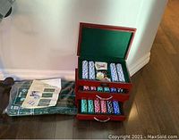 Front view showing two open wooden chip boxes and packaged game carpet