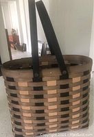 2015 large tote basket with dark and light brown woven wooden strips and two dark brown handles