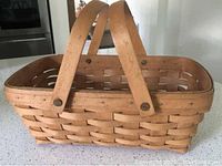Photo of a 1992 Market-type Longaberger basket with swing handles, showing woven wood and sturdiness.