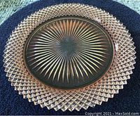 Pink glass round platter 10 inches wide showing diamond edge and starburst pattern center