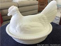 Photo of the 2-piece chicken shaped milk glass covered dish showing detailed feather and comb designs on lid and matching base bowl with beaded edge.