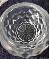 Close-up top view of the faceted glass bowl showing hexagonal pattern and sunburst bottom design.