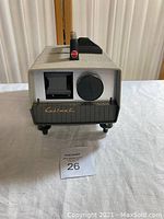 Front view of Manon Cabimat slide projector showing slide slot and focus dial