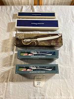 Boxes and original packaging for Reed & Barton, 21st Century Baroque, and International Silver Company serving utensils.