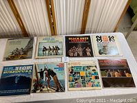 Lot of 8 Beach Boys vinyl album covers laid out flat, showing cover art and titles.