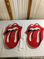 Front side of two foam mitts showing iconic Rolling Stones tongue and lips logo