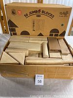 Set of 50 wooden blocks in original cardboard box showing various shapes packed tightly.