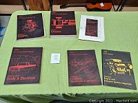Six 1973 Ford Truck Shop Manuals laid out on a table, showing covers for Volumes 1 to 6 and service specs and wiring diagrams.