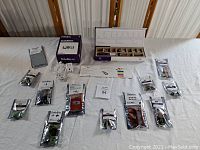 Full layout of the Little Bits kit on table showing CloudBit box, storage box with modules, multiple sealed Bit packets, and power adapters.