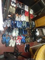 Overview of 35 pairs of shoes laid out on floor