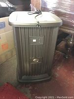 Front and partial side view showing vertical ribbed brown plastic casing, control display, and AirCare logo.