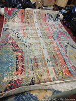 Full view of colorful patterned Safavieh Monaco rug laid out on floor showing pattern and size.