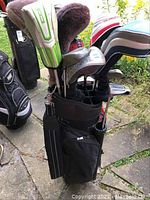 Full view of Datrek golf bag holding multiple men’s golf clubs with various headcovers and types of clubs visible