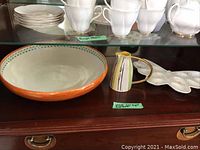 Shelf display of all three items including Royal Doulton bowl, Fliff Carr creamer, Lenox egg dish