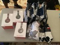 Overview of all items on table: headphones, T-shirts and socks