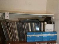 Shelf view of upright LaserDisc cases and stacked magazine boxes