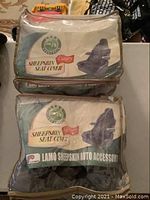 Two original LAMO branded sheepskin auto seat covers in clear plastic packaging with labels showing product detail and branding.