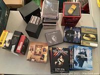 Overview of box sets and loose items including multi-CD box sets (Petula Clark, Easy Rock, Eagles, Bruce Springsteen), single CDs and The Bourne Ultimatum DVD