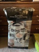 Box of 12-piece stainless steel copper bottom cookware set showing front artwork with pots and lids.
