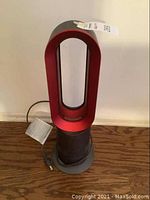 Front view of red oval loop amplifier and base