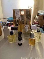 Photo showing five fragrance bottles in a group including Burberry, Bulgari, Hilfiger