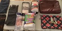 Items arranged on table: t-shirt, scarf, underwear packs, sleeves, watches