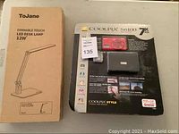 Nikon Coolpix S6100 camera unopened packaging and ToJane LED desk lamp boxed