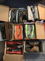 Overall view of eight open shoeboxes showing all pairs