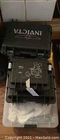 Stacked Invicta and Disney hard plastic watch cases atop clear plastic bin