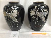 Front view of two large black enamel vases showing detailed mother-of-pearl bird and flower inlay designs.