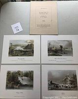 Photo of four colorful early Canadian scene engravings by W.H. Bartlett laid out on a light surface.
