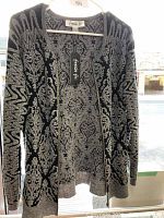 Photo of the Fresh Fx women's zippered sweater displayed on a hanger showing the front pattern and design.