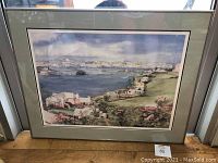 Front view of framed print showing Bermuda harbour scene, green double mat, silver frame