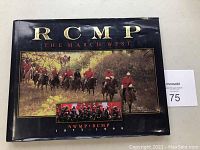 Front cover of the hardcover book showing mounted RCMP officers in red serge uniforms and a smaller inset group image, with title 'RCMP The March West' and subtitle 'NWMP RCMP 1873-1999'.