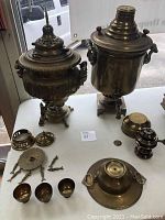 Front view showing both samovars and all accessories spread on table