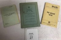 Three vintage military manuals/documents: pale green Canadian Army document with crossed swords emblem, pale green 'A Manual for Drivers in Germany' booklet, and tan US Army Field Manual FM 6-20-1 dated 1961.