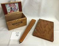 Handcrafted wooden guest book, vintage wooden brush, and wooden cigar box with 'Flor Fina 8-5-8' label.