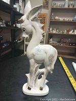 Full side view of vintage ceramic donkey figurine showing detailed features and base, with measuring tape side showing 13 inches tall.