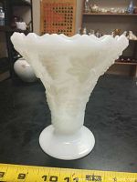 Front and side view of white milk glass vase on black surface with measuring tape showing approximately 6 inches tall.