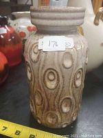 Full view of vintage West German vase showing oval and circular raised patterns with color gradient from beige to brown