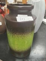 Front view of the vintage West German pottery vase showing the color gradient from brown to green and the shape and size.