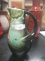 Side view of the ceramic pitcher showing green to black gradient and handle