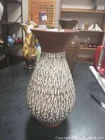 Full view of the vintage pottery vase showing its textured exterior pattern and shape.