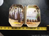 Open double serving tray with hand-painted autumn forest and water scenes on each side, showing ruler for scale around 12 inches wide open.