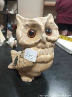Front view of vintage ceramic owl figurine with large eyes and textured details.